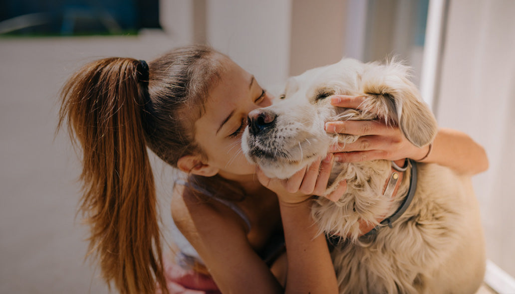 Girl Snuggling Dog